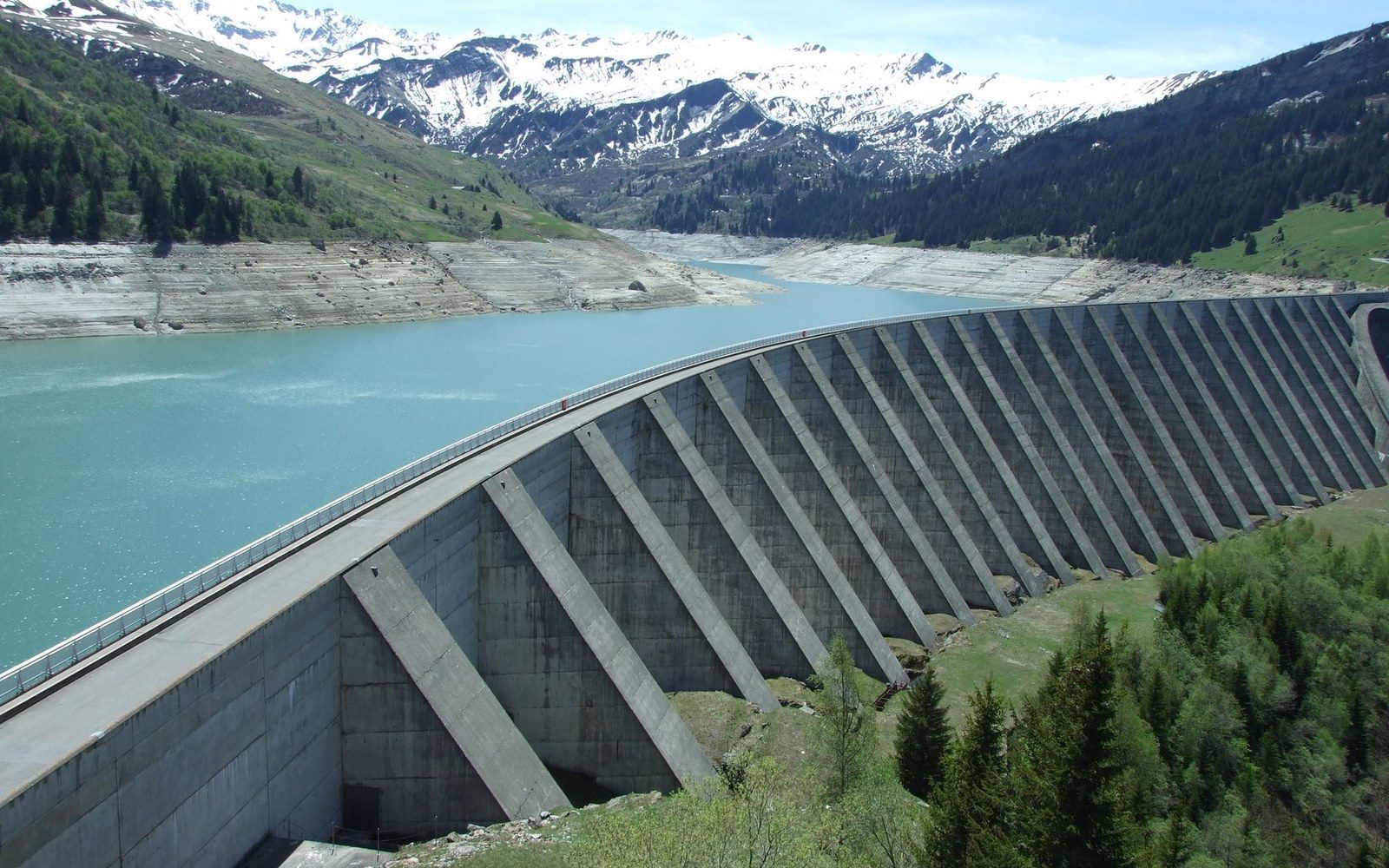 The Chevril dam wall above the Tignes reservoir, concrete face running from frame edge to frame edge
